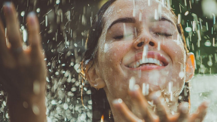 Woman under waterfall