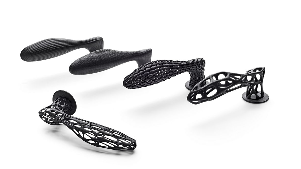 Four intricate 3D-printed components with organic lattice designs, produced from INFINAM® PA12 powder using Multi Jet Fusion (MJF) for advanced applications.