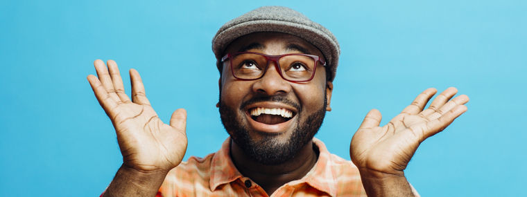 It's incredible! Portrait of a happy and excited man looking up with mouth open and both arms up
