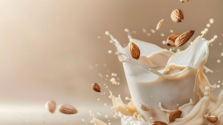 Isolated almond milk splash with swirl of almonds organic vegan liquid. Concept Food photography, Almond Milk, Splash effect, Organic, Vegan