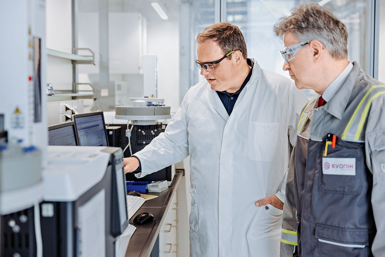 Andreas Vorholt and Robert Franke read the values on a chromatograph.