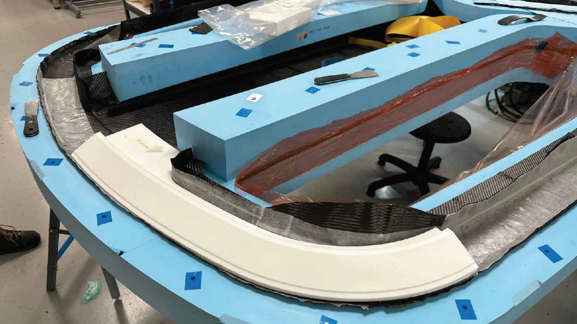 Precisely machined ROHACRYL™ SW 80 foam core sections are positioned within the mold and integrated with carbon fiber reinforcements to create a high-performance sandwich construction.