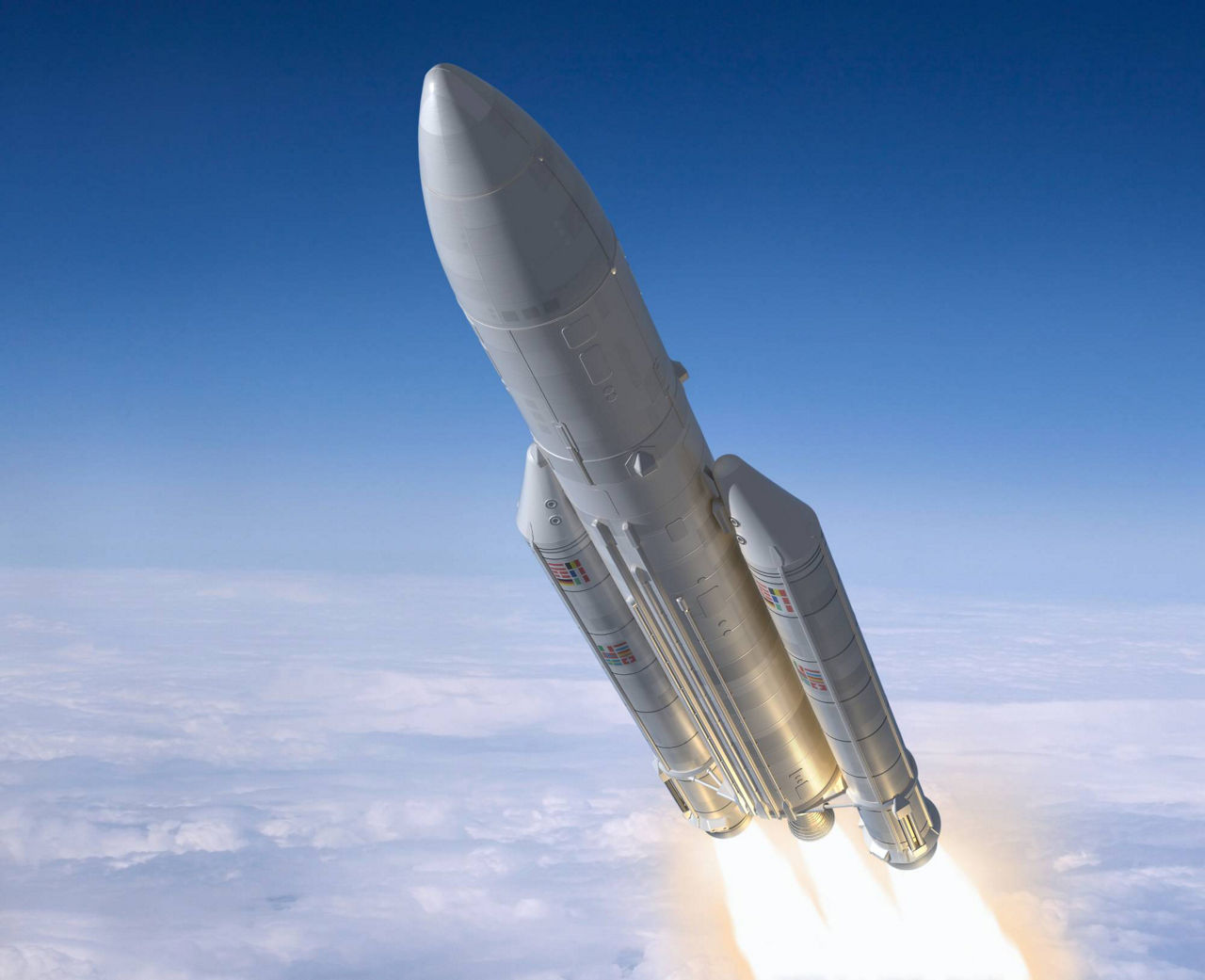 Rocket ascending above clouds with bright engine flames against a clear blue sky.