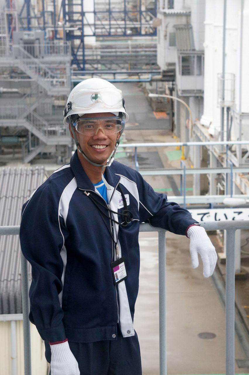 Evonik-Ingenieure Saefuludin in der Anlage in Yokkaichi. Er trägt Helm, einen Arbeitsanzug und weiße Schutzhandschuhe.
