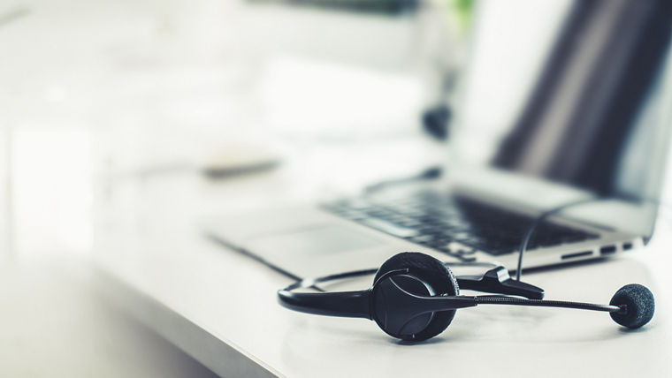 Headset and customer support equipment at call center ready for actively service . Corporate business help desk and telephone assistance concept .