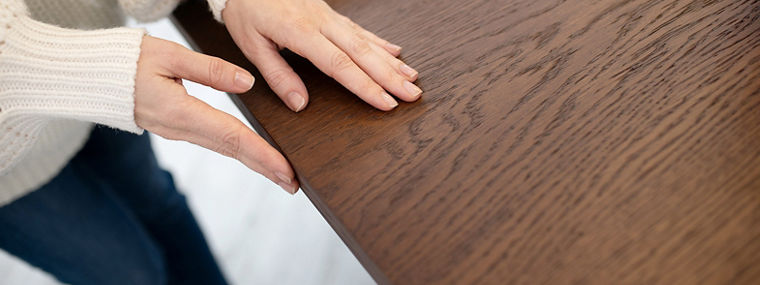 Touching the table. Close up of womans hands touching the table