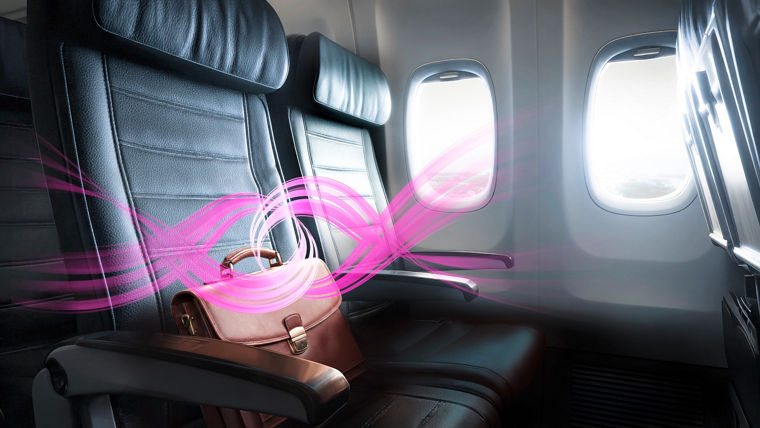 Empty airplane seat cabin leather seats at sunset with window view of clouds and warm light creating calm travel atmosphere