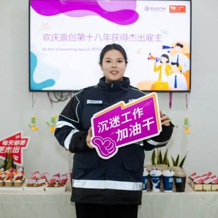A person poses in front of a colorful mural featuring the name "Changsha" and playful illustrations.