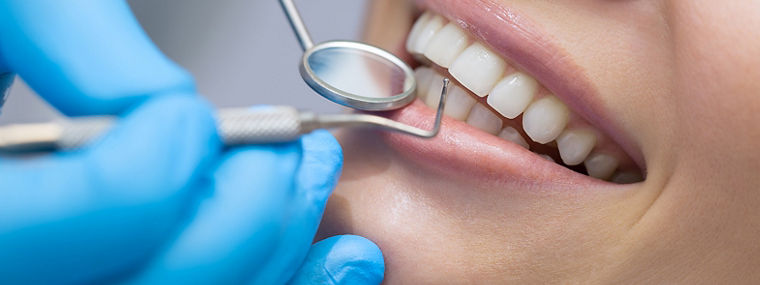 Girl with beautiful white teeth on reception at the doctor dentist.