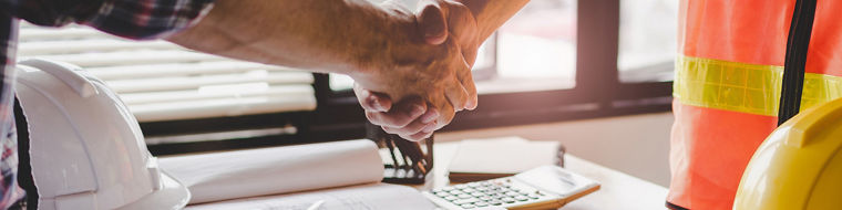 construction worker team hands shaking after consultation meeting to greeting start up plan new project contract in office center at construction site, teamwork, partnership and contractor concept