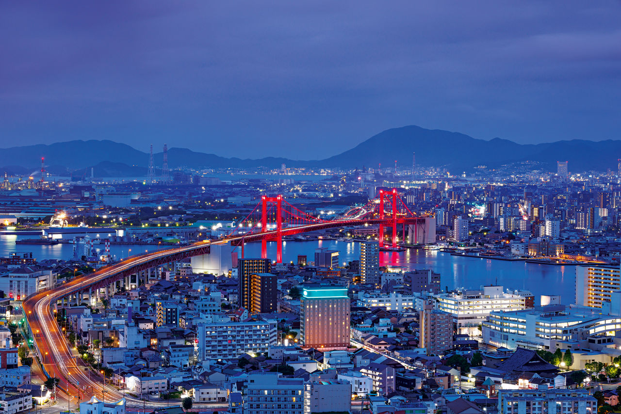 A drone shot of the area around the Wakato Bridge, which is illuminated in red.