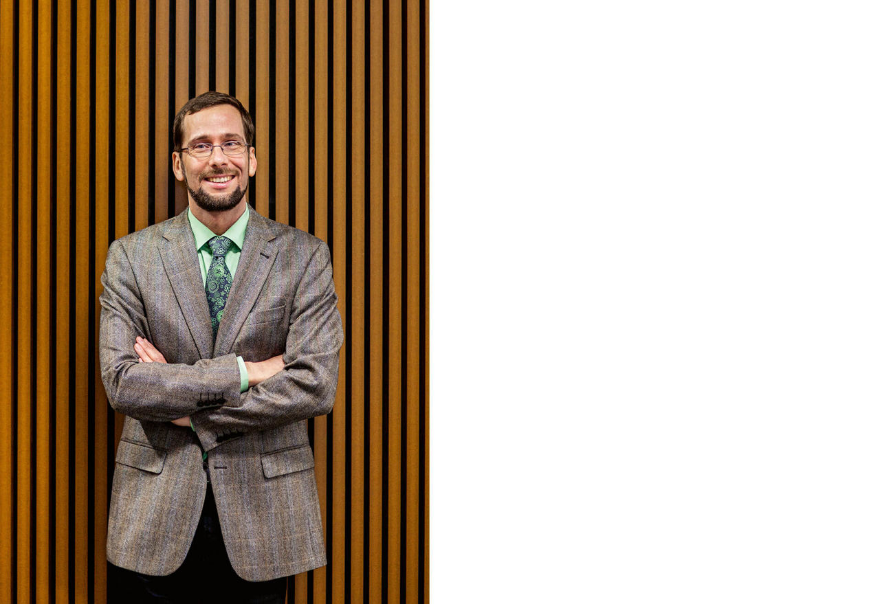 Prof. Quaschning steht vor einer braun gestreiften Wand aus Holzpaneen.