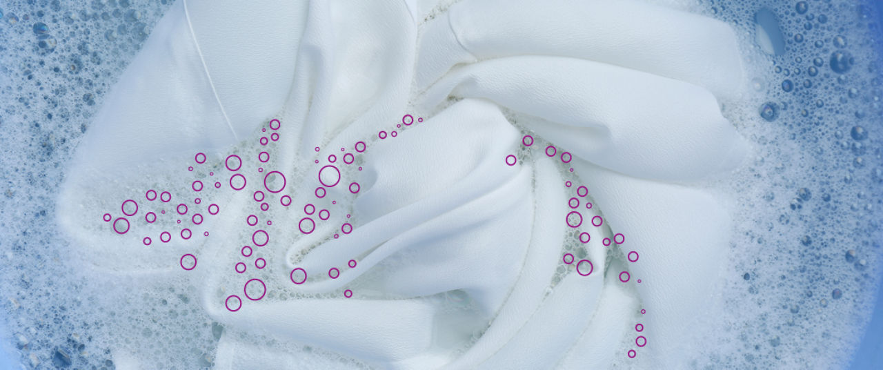 White textiles in wash water demonstrating hygienic laundry and textile bleaching with peracetic acid