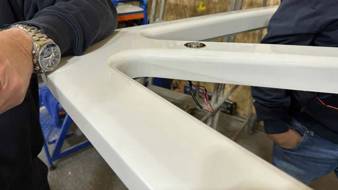 White finished composite roof structure in a workshop during final assembly.