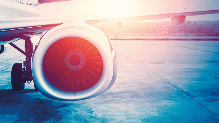 Close-up of an airplane jet engine with visible fan blades, illuminated by warm sunlight—symbolizing the high-performance applications of VERSALINK® materials.