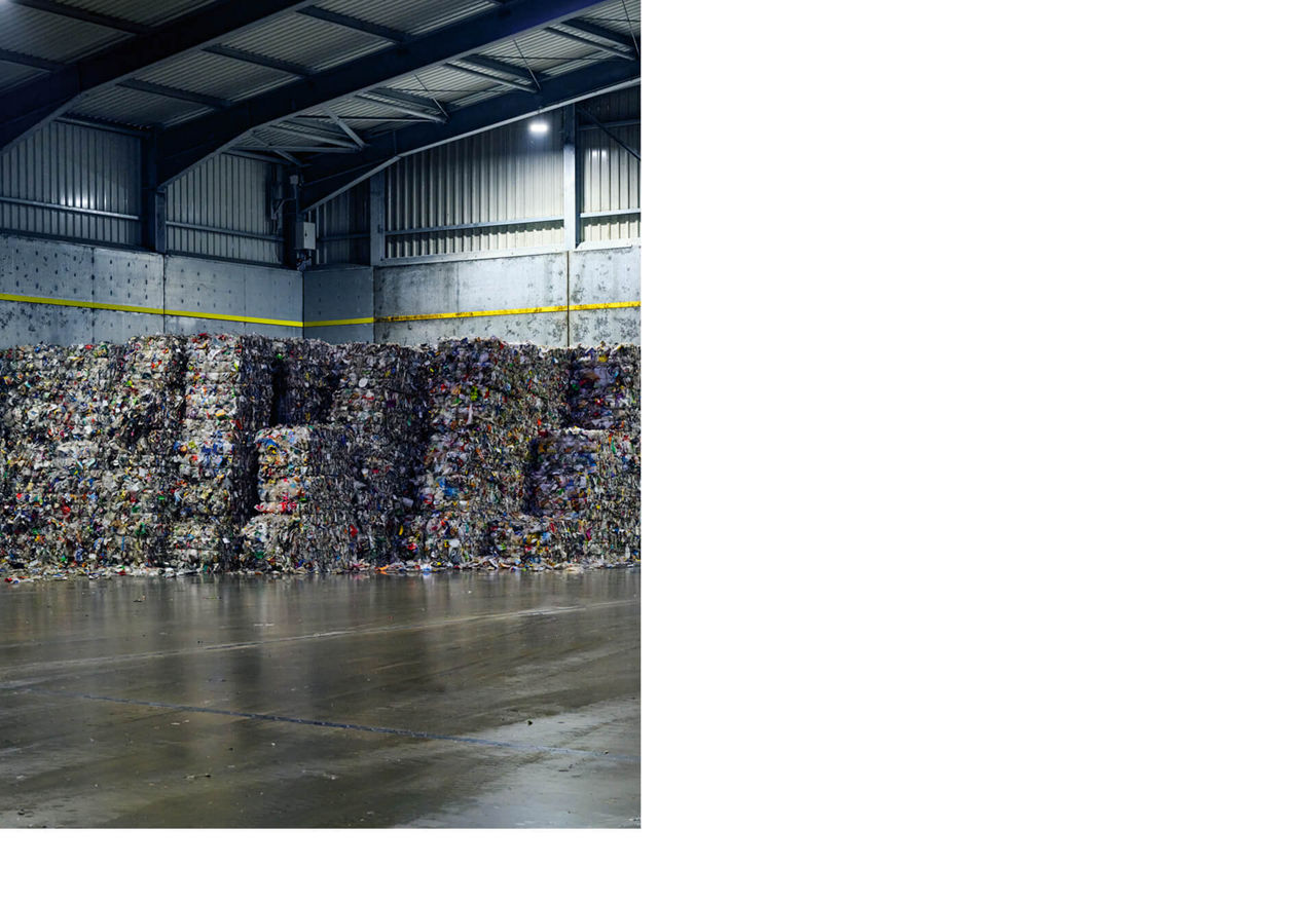 Collected plastic packaging awaits further processing in the incoming goods warehouse