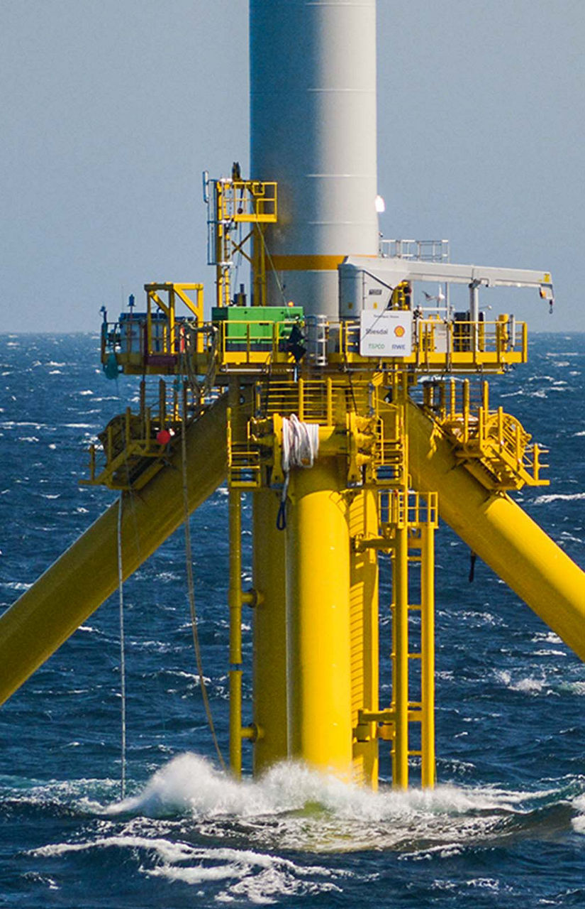 A tug pulls the floating platform out to sea.