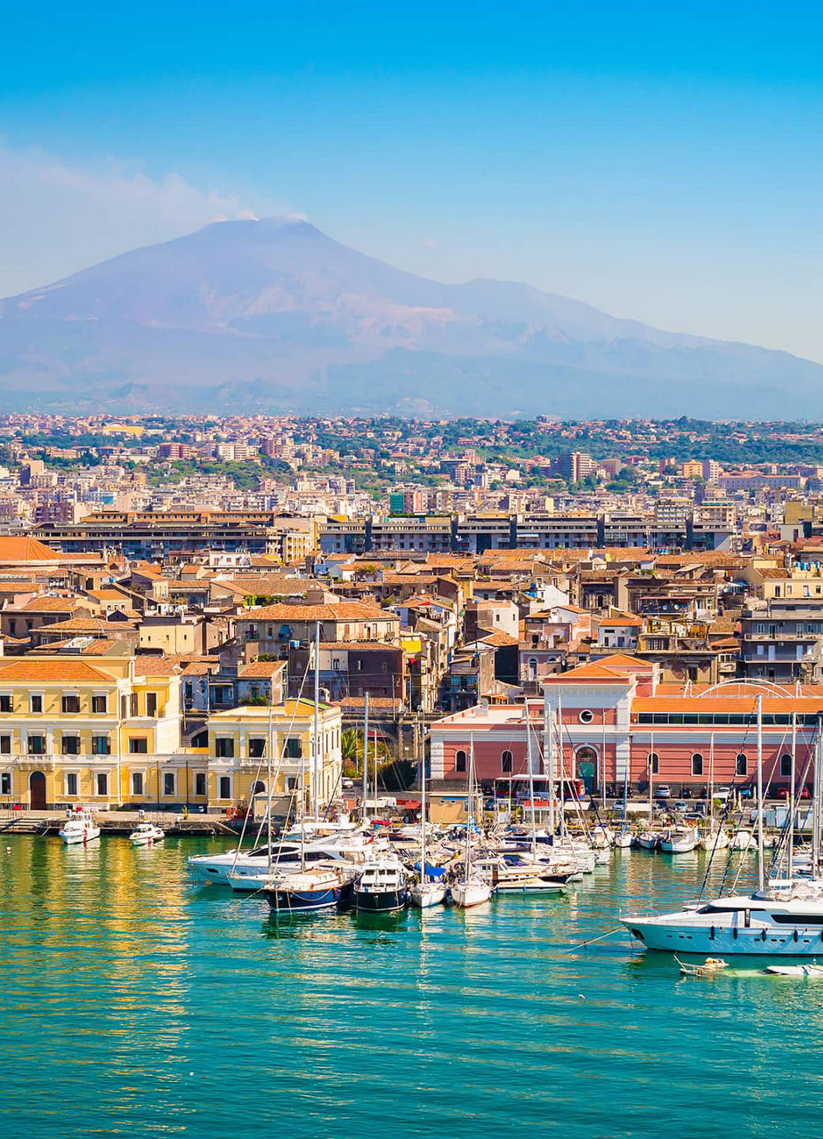 Port of Catania with the city and Mount Etna in the background