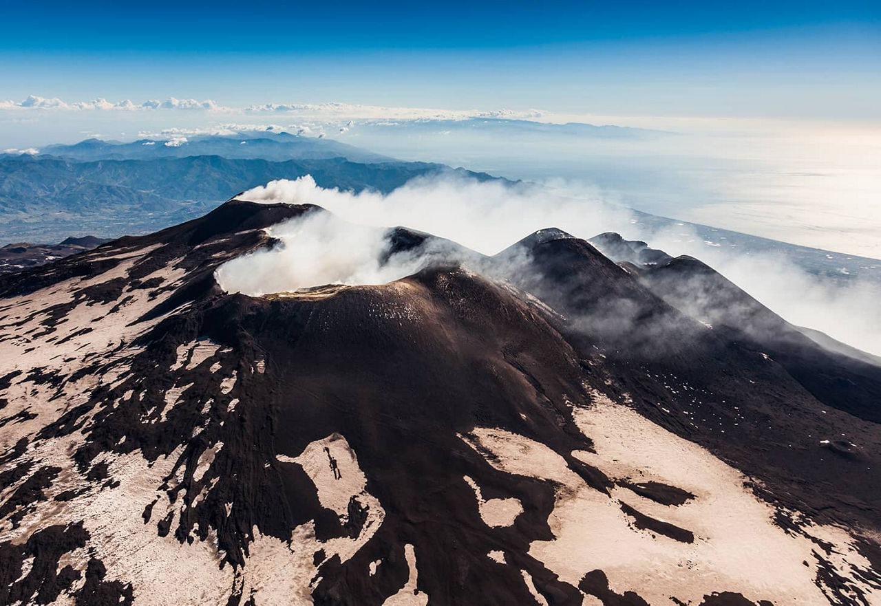 View of Mount Etna with smoking steam clouds