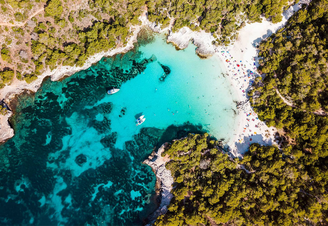 Cala en Turqueta surrounded by forest and rocks