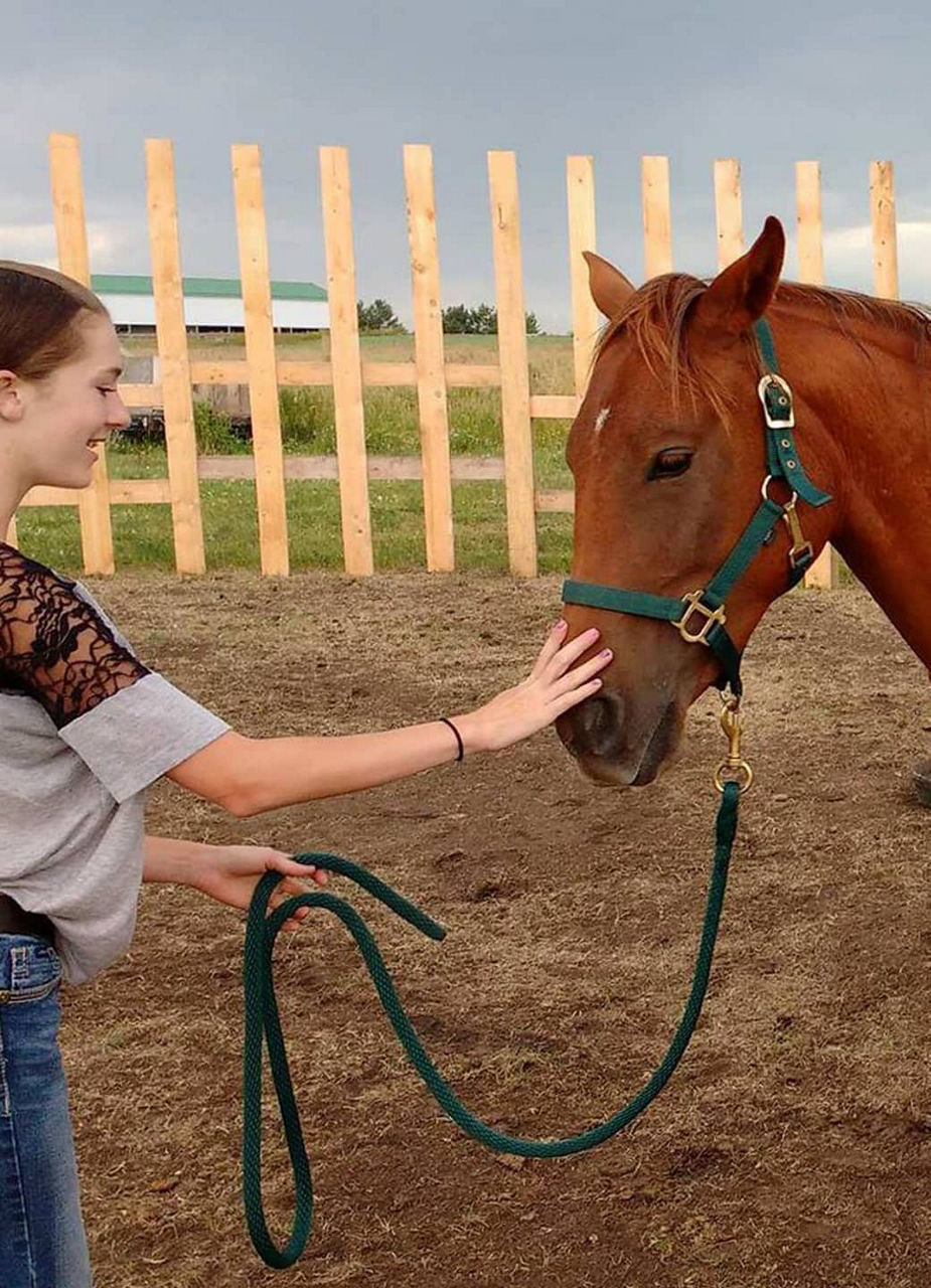 Volunteer and horse in Alberta, Canada