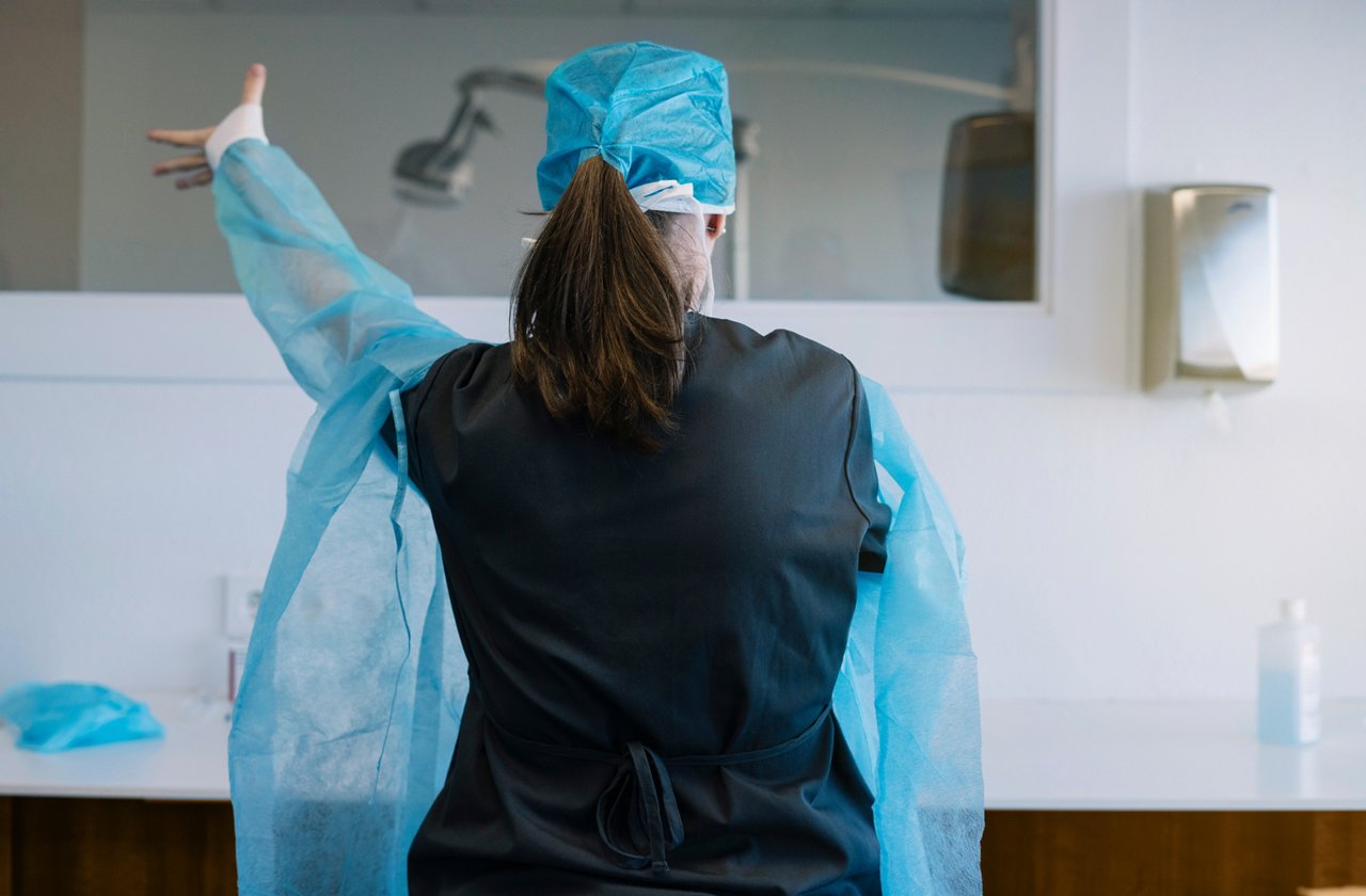 Female doctor who putting on the robe