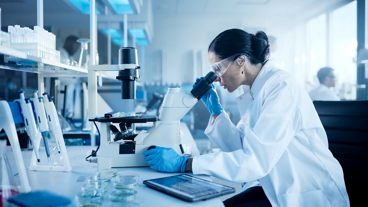 lab worker with microscope