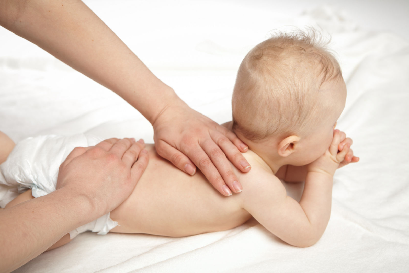 Baby massage back with hands