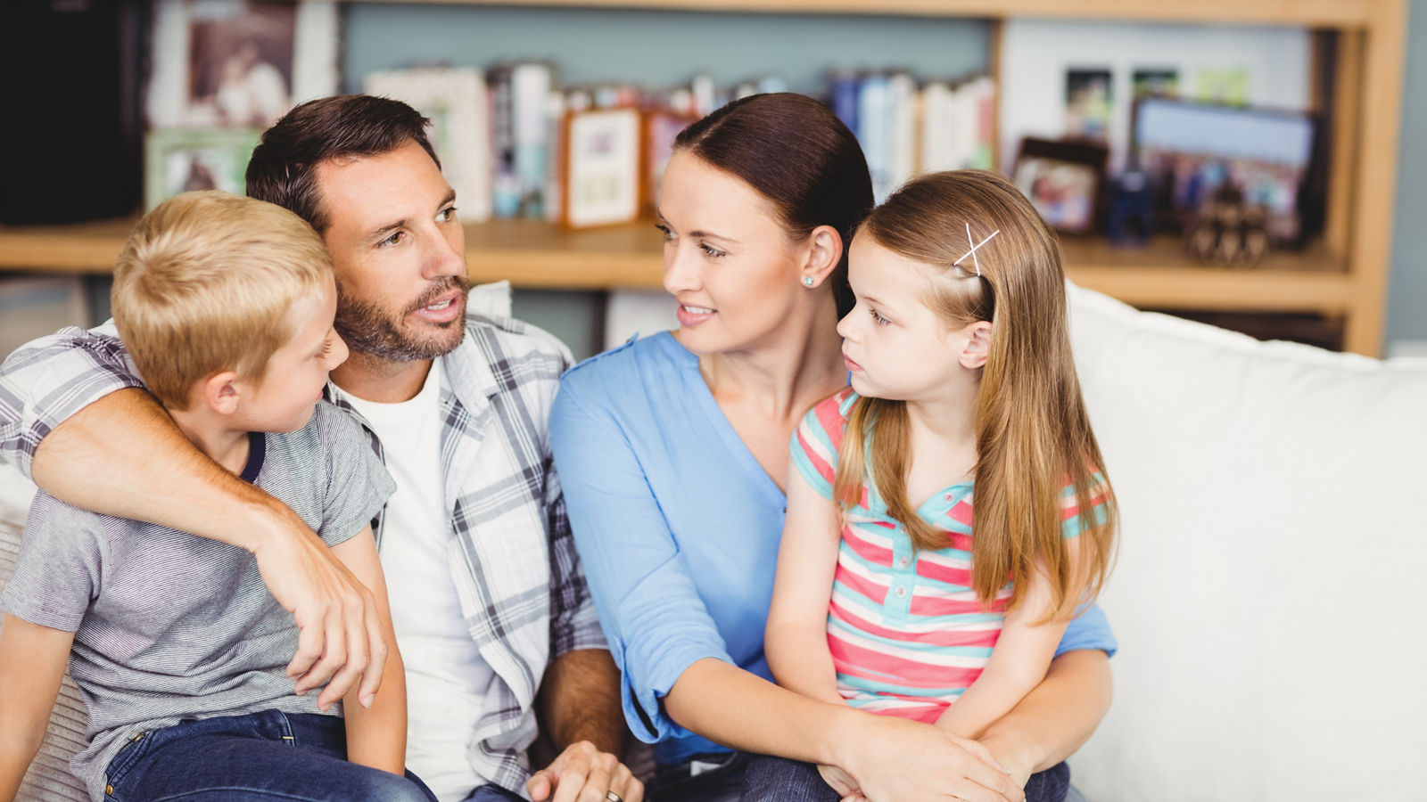 Close-up of family discussing on sofa