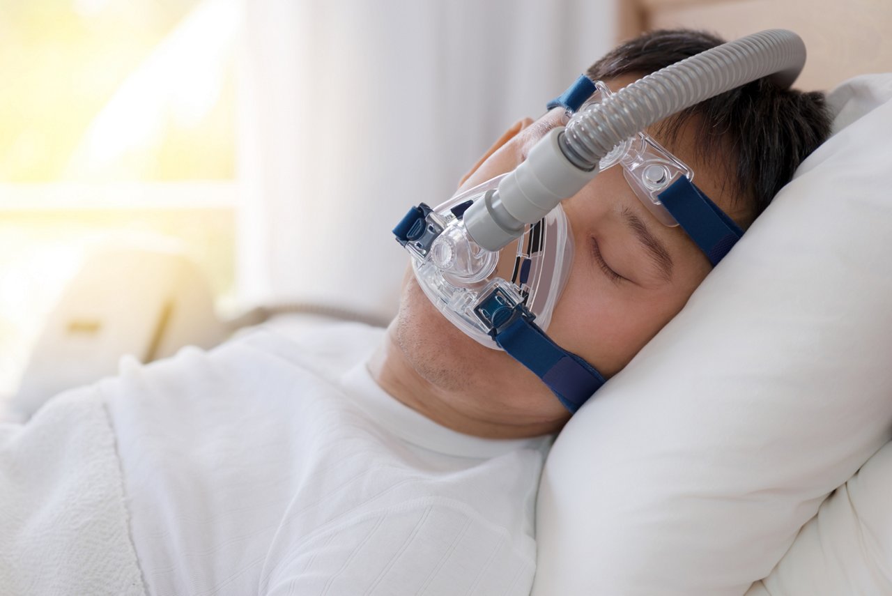 Sleep apnea therapy, Man sleeping in bed wearing CPAP mask.
Healthy senior man sleeping deeply, happy on his back without snoring