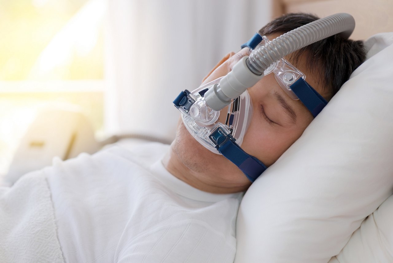 Sleep apnea therapy, Man sleeping in bed wearing CPAP mask.
Healthy senior man sleeping deeply, happy on his back without snoring