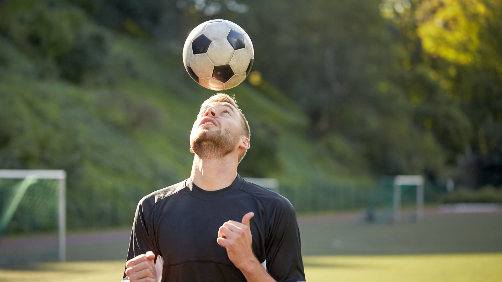 soccer player playing with ball on field