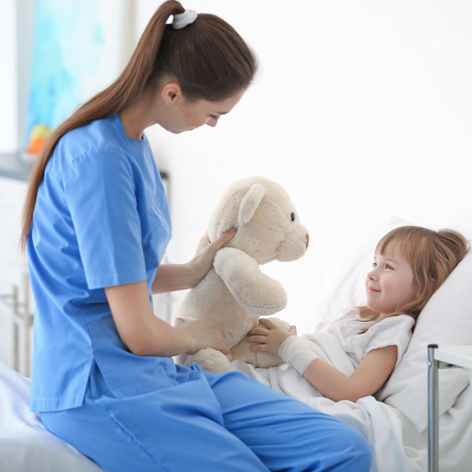 Doctor visiting little girl in hospital room