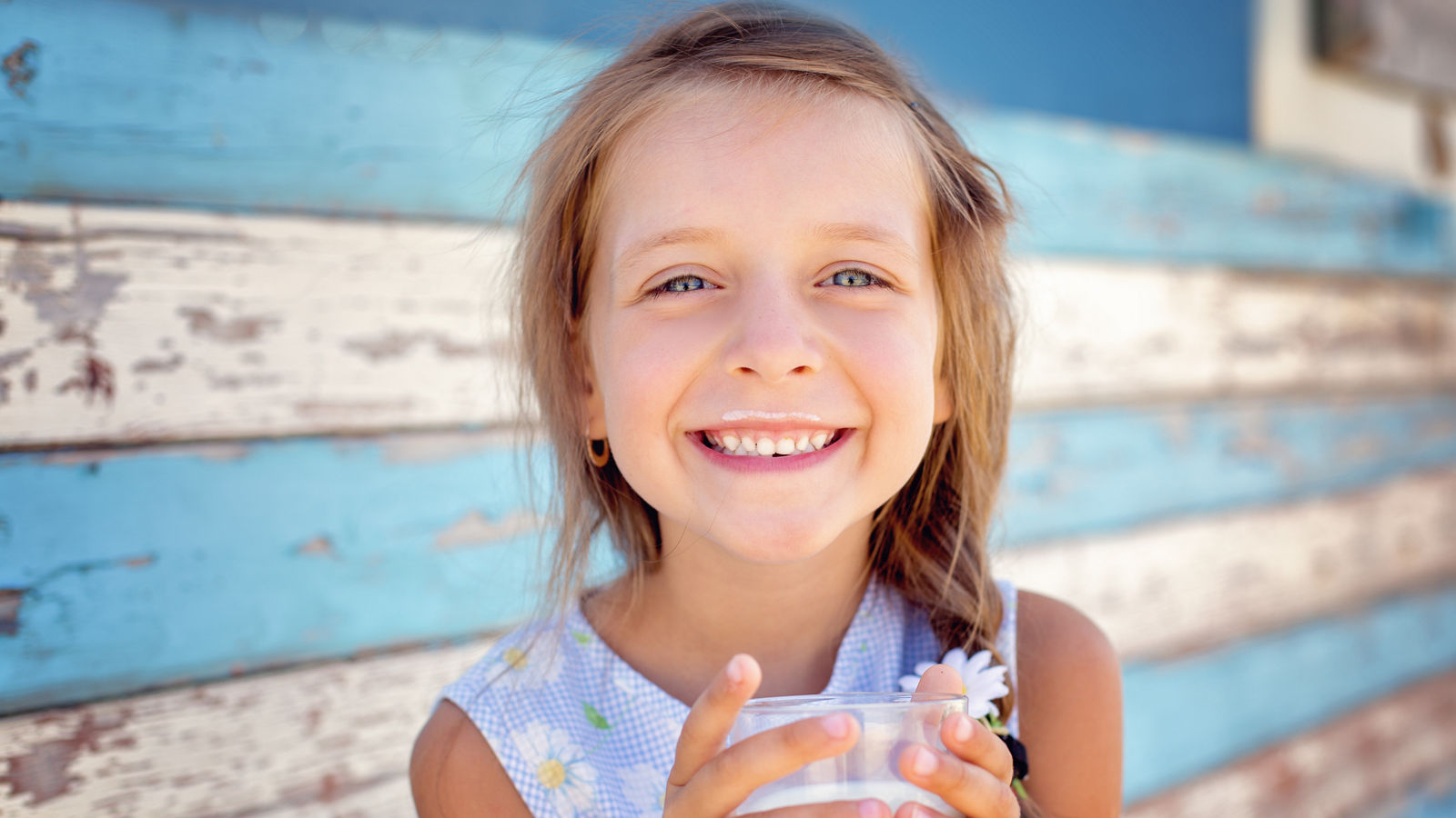 little girl is drinking milk 