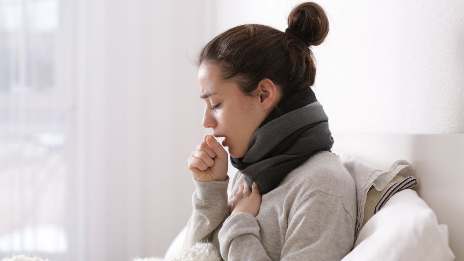 Young ill woman in bed at home