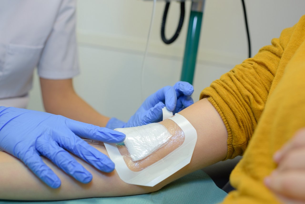 Plaster being applied over patient's arm