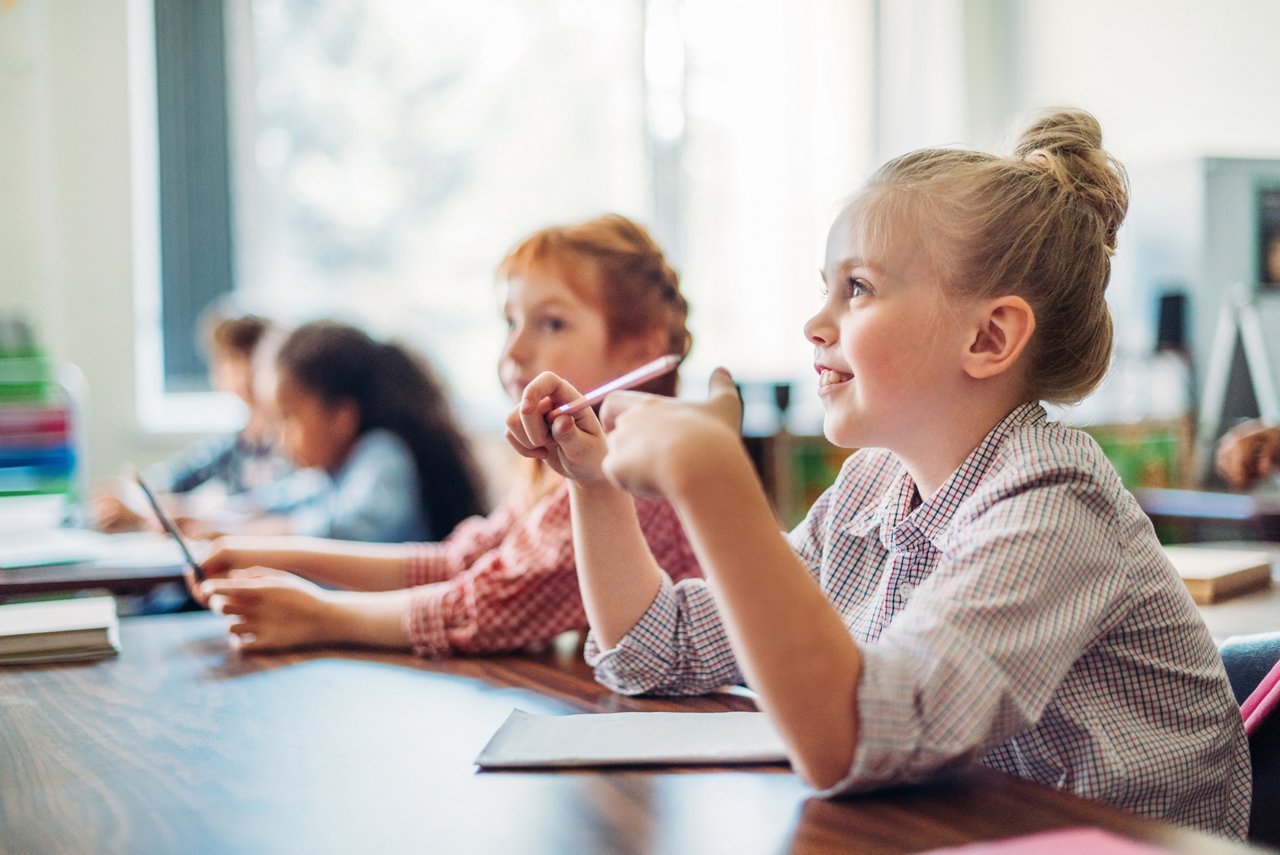 concentrated beautiful schoolgirls sitting in class