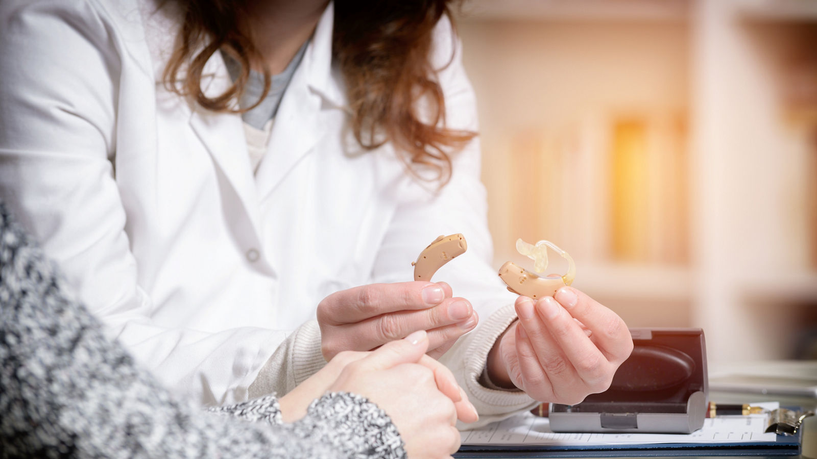 Doctor showing hearing aid