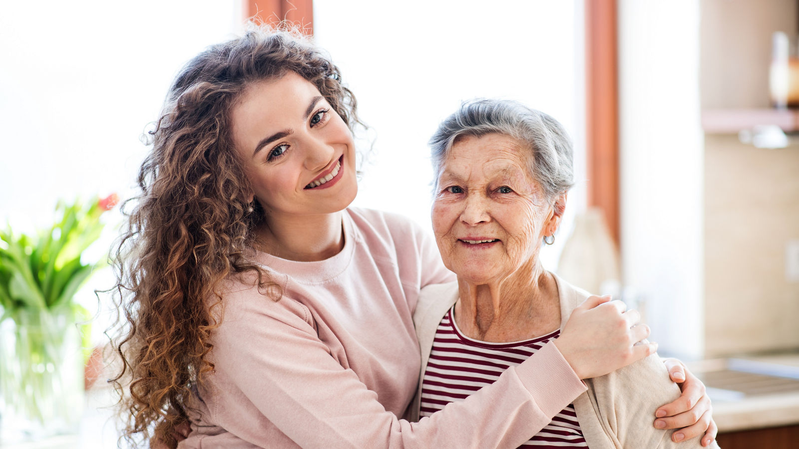 A teenage girl with grandmother at home.