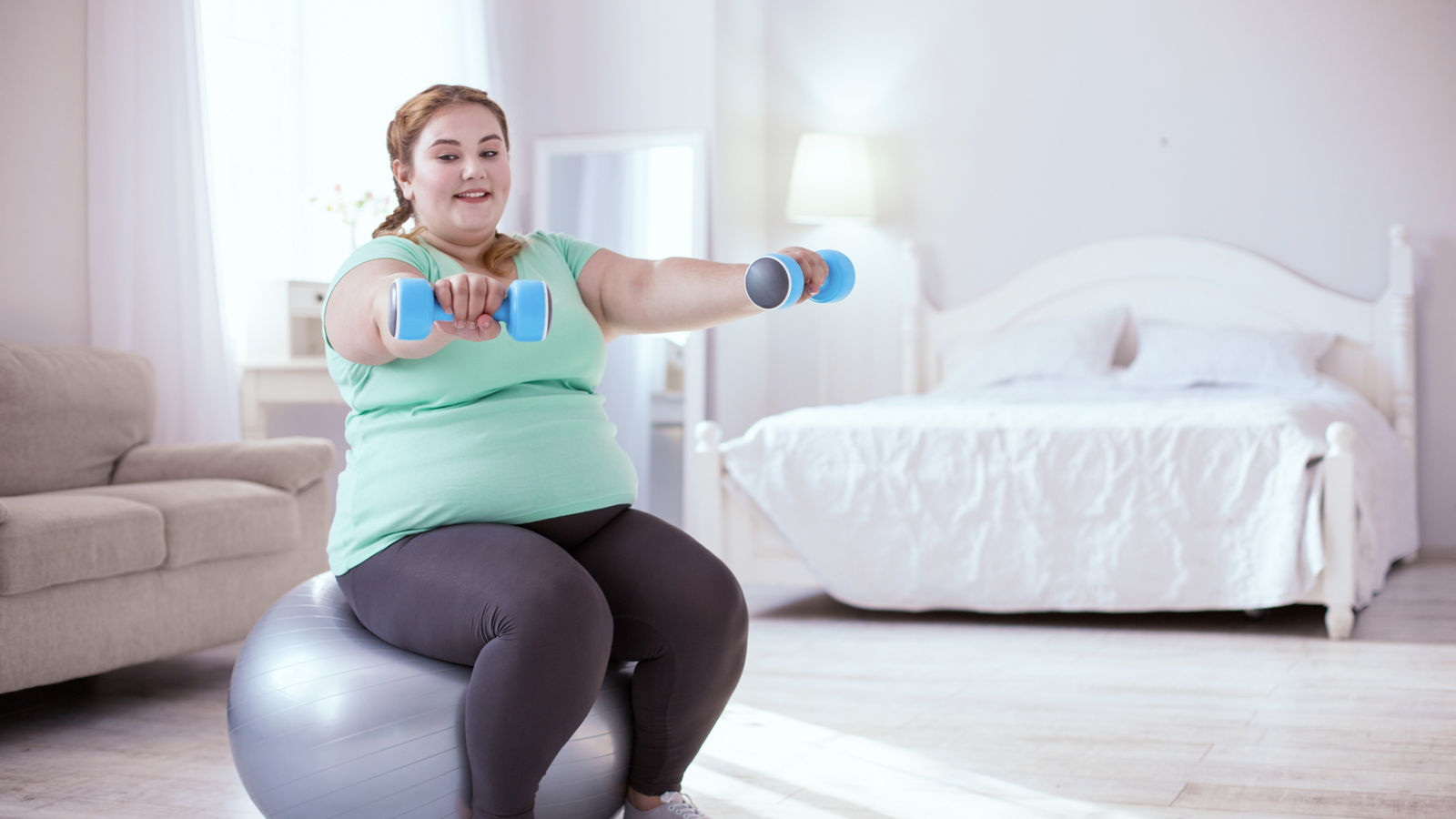 Stout young woman exercising to keep fit