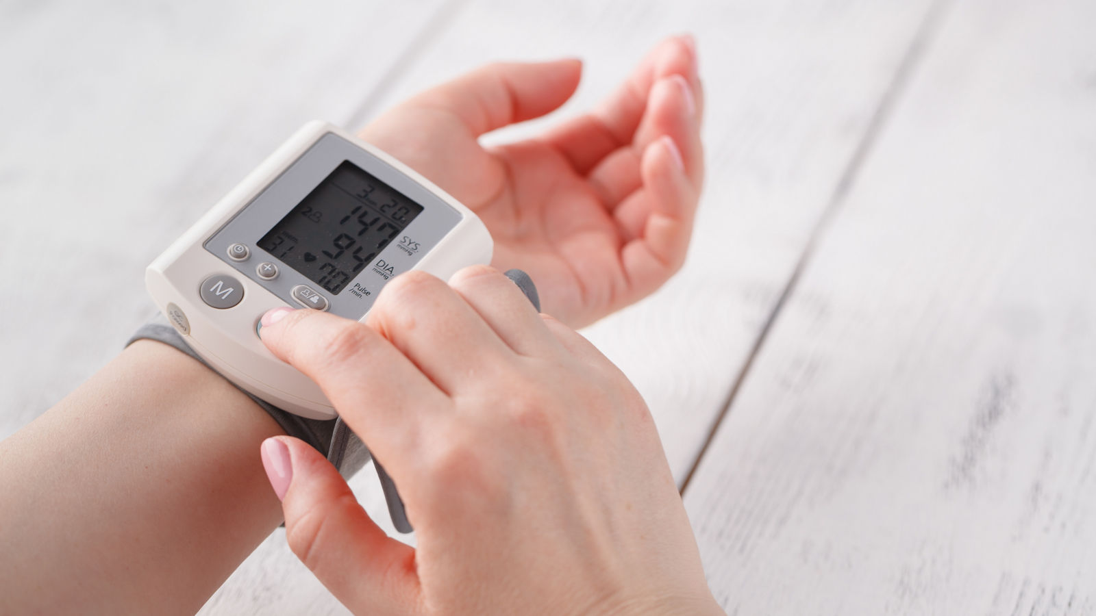 woman measures to herself arterial blood pressure, hands close-up