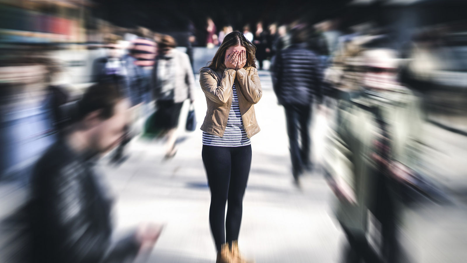 Panic attack in public place. Woman having panic disorder in city. Psychology, solitude, fear or mental health problems concept. Depressed sad person surrounded by people walking in busy street.