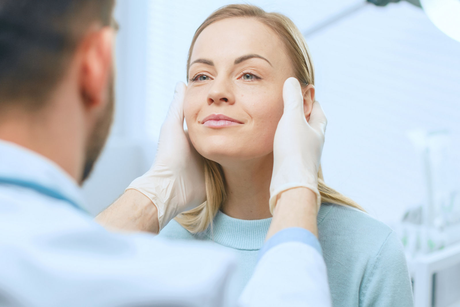 Plastic / Cosmetic Surgeon Examines Beautiful Woman's Face, Touches it with Gloved Hands, Inspecting Healed Face after Plastic Surgery with Amazing Results.