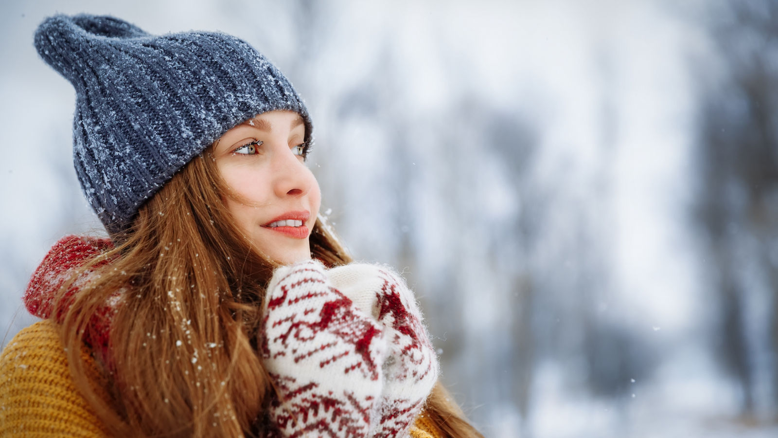 Winter young woman portrait. Beauty Joyful Model Girl laughing and having fun in winter park. Beautiful young female outdoors, Enjoying nature, wintertime
