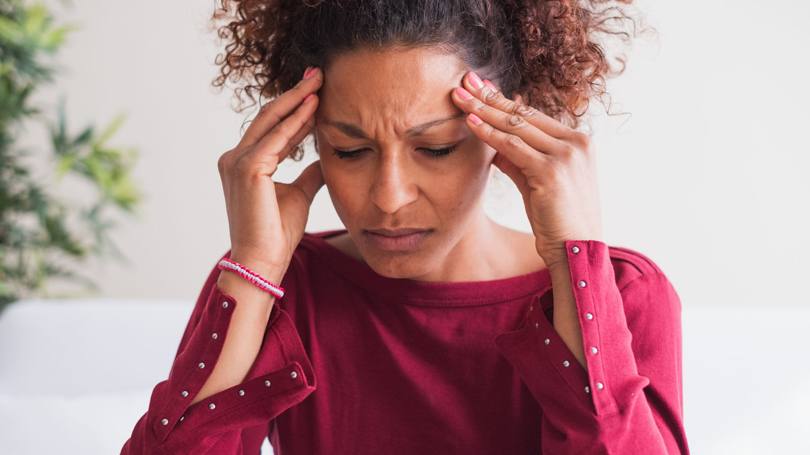 Woman suffering from terrible headache massaging temples