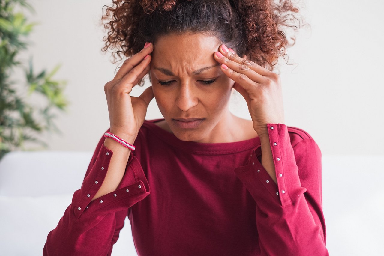 Young black woman suffering strong headache