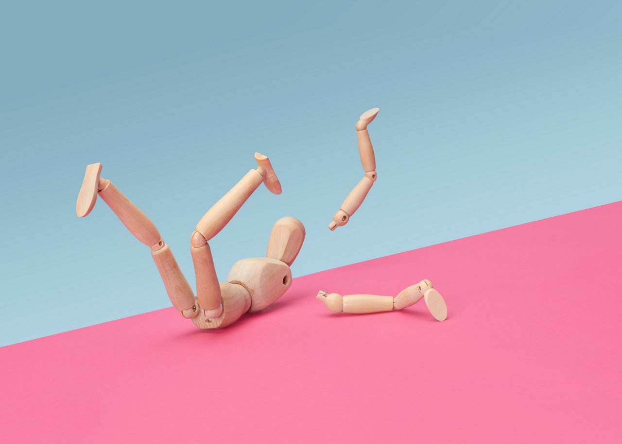 Wooden modelling doll fallen over and broken