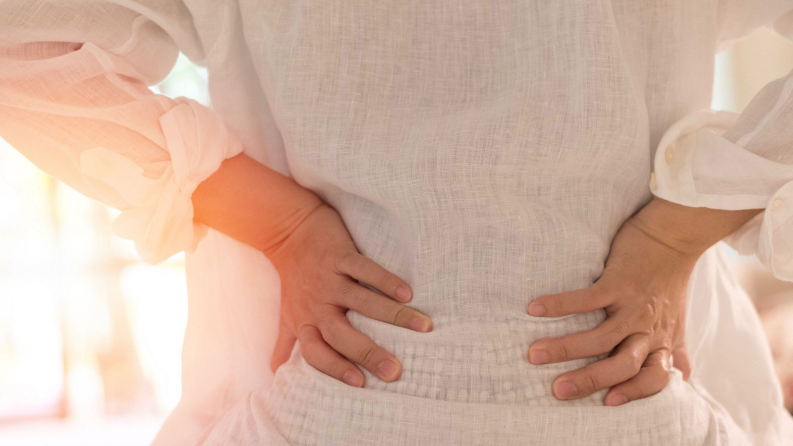 Back pain in woman concept. Female patient hurt from lower backache from bowel and bladder problems, palvic inflammatory disease (PID) or motherhood pregnancy.