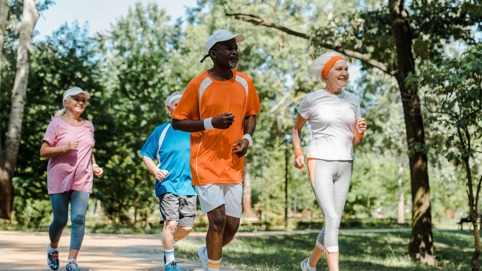 happy multicultural and retired men and women running in park