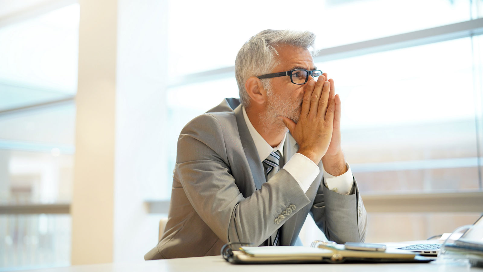 Stressed out businessman sitting at desk
